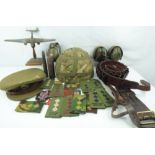 Various military collectibles to include an army camouflage hard hat, green ear defenders,