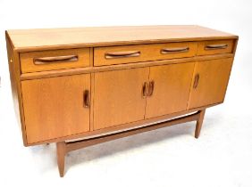 G PLAN; a mid-20th century teak sideboard with three drawers over four doors,