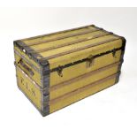 A metal bound canvas covered travelling trunk with leather carrying handles, initialled 'E.L.S.