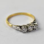 An 18ct gold ring, the principal claw set diamond approx 0.