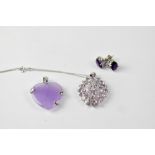 SWAROVSKI; a silver pendant set with amethyst in a flower head style, marked SCS,