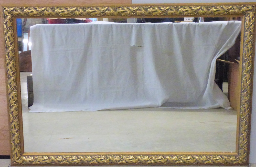 A large rectangular wall mirror in an ornate gilt wood frame, 79 x 120cm.