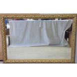 A large rectangular wall mirror in an ornate gilt wood frame, 79 x 120cm.