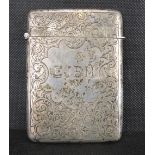 A Victorian hallmarked silver card case with all-over scroll and floral decoration,