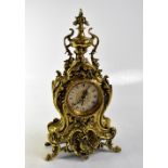 A reproduction French-style gilt brass mantel clock in the Rococo manner,