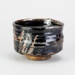 CHARLES BOUND (born 1939); a wood fired stoneware chawan covered in tenmoku and kaki glaze,