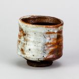 CHARLES BOUND (born 1939); a wood fired stoneware yunomi covered in shino glaze, impressed mark,