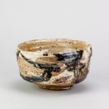 CHARLES BOUND (born 1939); a wood fired stoneware chawan partially covered in white and tenmoku