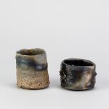 SEBASTIAN BLACKIE (born 1949); two wood fired stoneware sake 'whisky schnapps' cups, tallest 7cm (