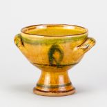 CLIVE BOWEN (born 1943); a slipware chalice covered in honey glaze with green decoration, height