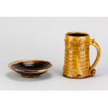 CLIVE BOWEN (born 1943); a large slipware mug covered in honey glaze with applied decoration, height