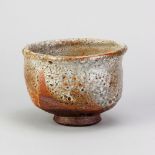 CHARLES BOUND (born 1939); a wood fired stoneware chawan covered in shino glaze, impressed mark,