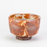 CHARLES BOUND (born 1939); a wood fired stoneware chawan covered in shino glaze, impressed mark,