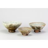 CHARLES BOUND (born 1939); a graduated trio of wood fired stoneware footed bowls partially covered