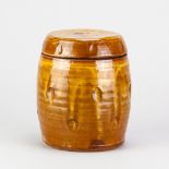 CLIVE BOWEN (born 1943); a slipware biscuit barrel covered in honey glaze with impressed decoration,