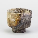 CHARLES BOUND (born 1939); a wood fired stoneware yunomi covered in grey glaze with pinkish hues,