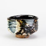 CHARLES BOUND (born 1939); a wood fired stoneware chawan partially covered in grey glaze with