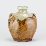MIKE DODD (born 1943); a stoneware lugged bottle covered in iron glaze with paddled decoration and