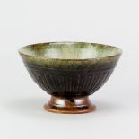 RICHARD BATTERHAM (1936-2021); a stoneware fluted tazza covered in green ash and tenmoku/cobalt