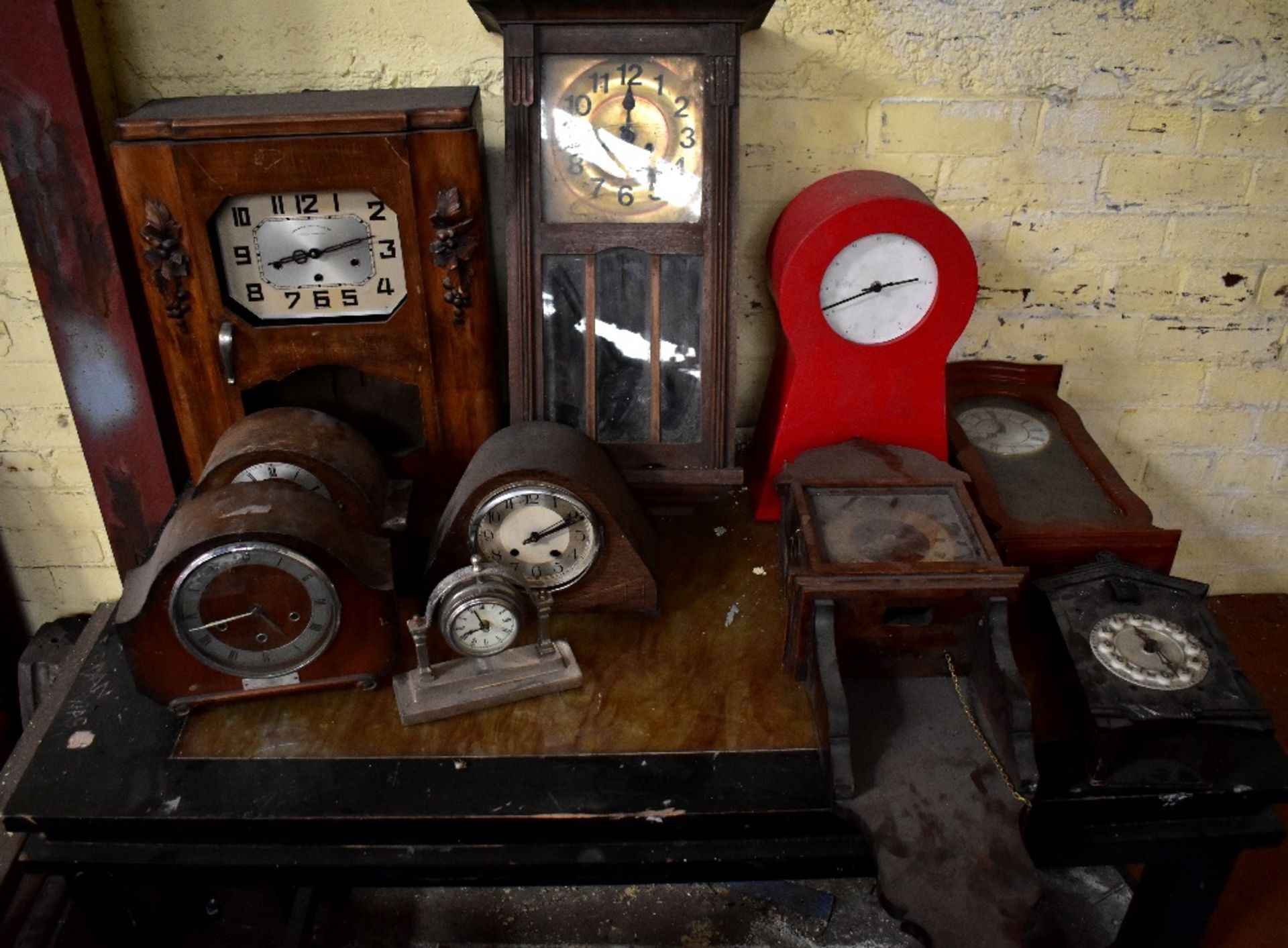 Various wall and mantel clocks, also a grandmother clock, in various states of disrepair (13).