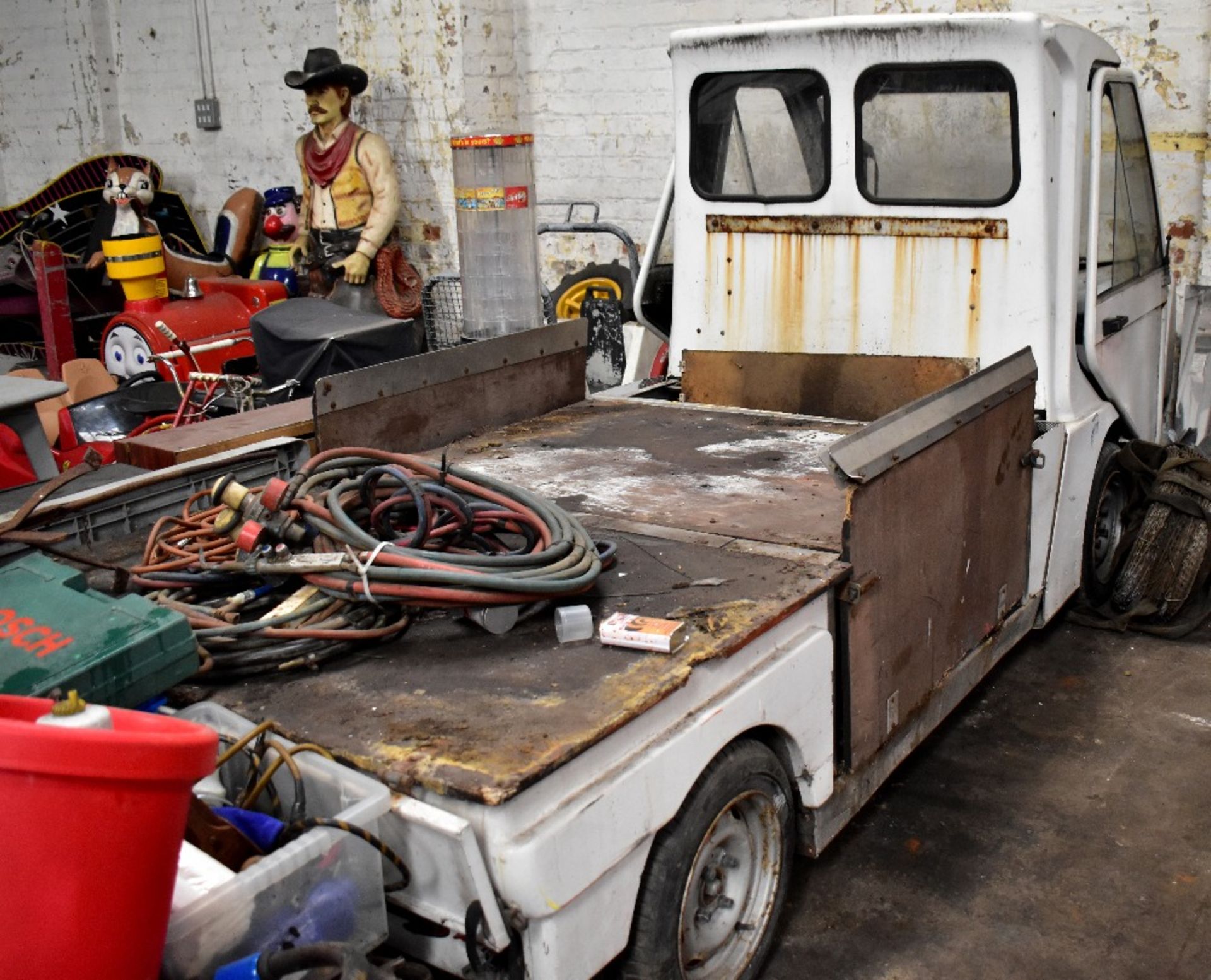 A left hand drive electric airport shuttle truck, for restoration (lacking batteries).