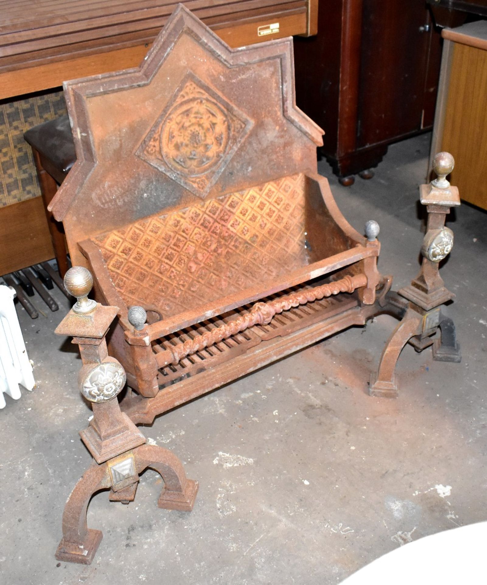 A large cast iron Gothic fire grate, height 92cm, width 116cm, depth approx 50cm (af).