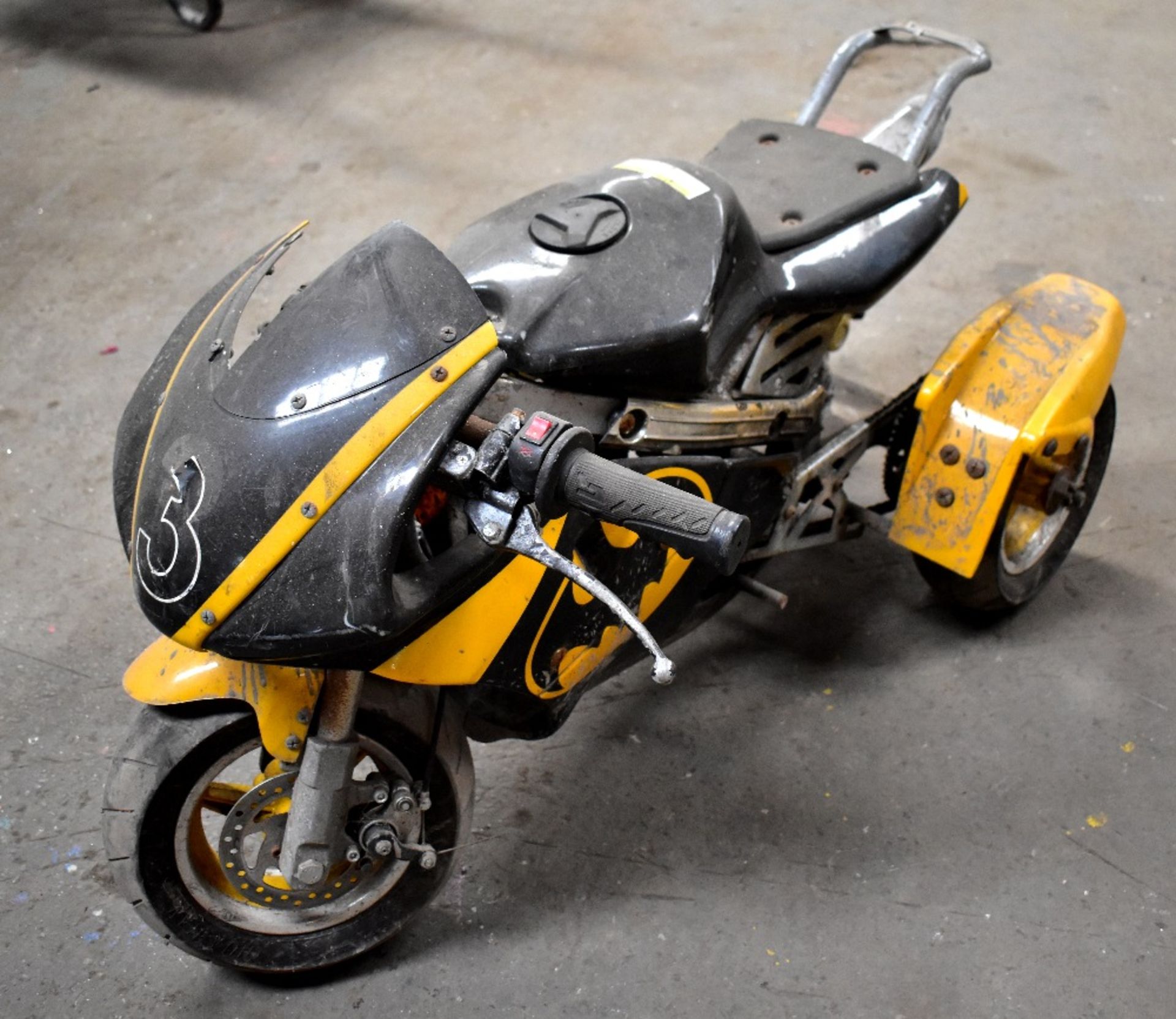 A Minimoto trike, for restoration (some aesthetic damage).