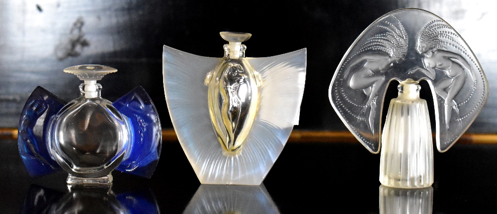 LALIQUE; three contemporary clear glass and plastic perfume bottles (3).Additional