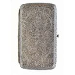 An Eastern white metal cigarette case of rectangular form with cast scrolling detail, 10 x 6cm,