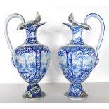 A pair of 19th century Dutch Delft flagons with folded rims, decorated in panels depicting sailing