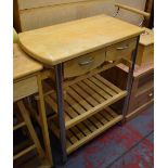 A kitchen island workstation raised on wheels, with two drawers above twin slatted lower supports,