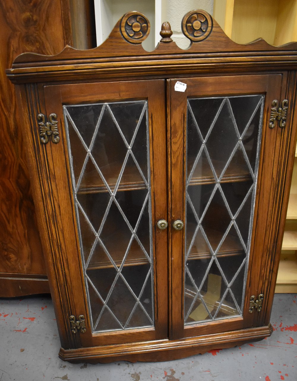 A reproduction oak leaded glazed hanging corner cupboard, width 68cm.