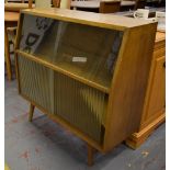 A 1960s/70s glazed side cabinet raised on angled supports, height 89cm, width 91.5cm.