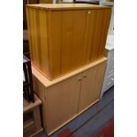 A contemporary pine two-door side cabinet, width 82cm and a further two-door side cabinet,