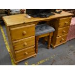 A contemporary pine kneehole dressing table, length 134cm and a stool (2).