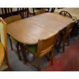 A mahogany drop-leaf dining table raised on cabriole legs to pad feet,