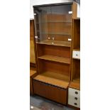 A side cabinet with twin glazed upper doors above a shelf and twin lower cupboard doors,