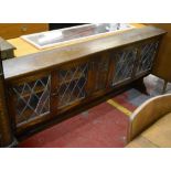 A reproduction oak side cabinet of narrow proportions,