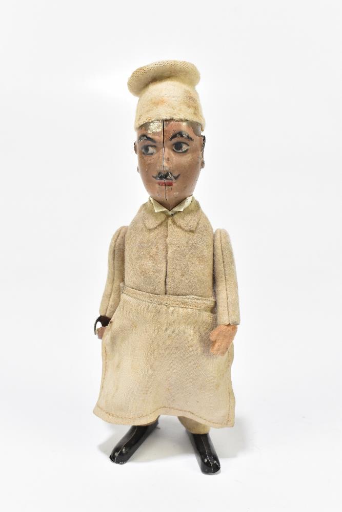 SCHUCO; a German tinplate clockwork model of a chef, with felt clothes and cotton apron, height 16. - Bild 2 aus 6