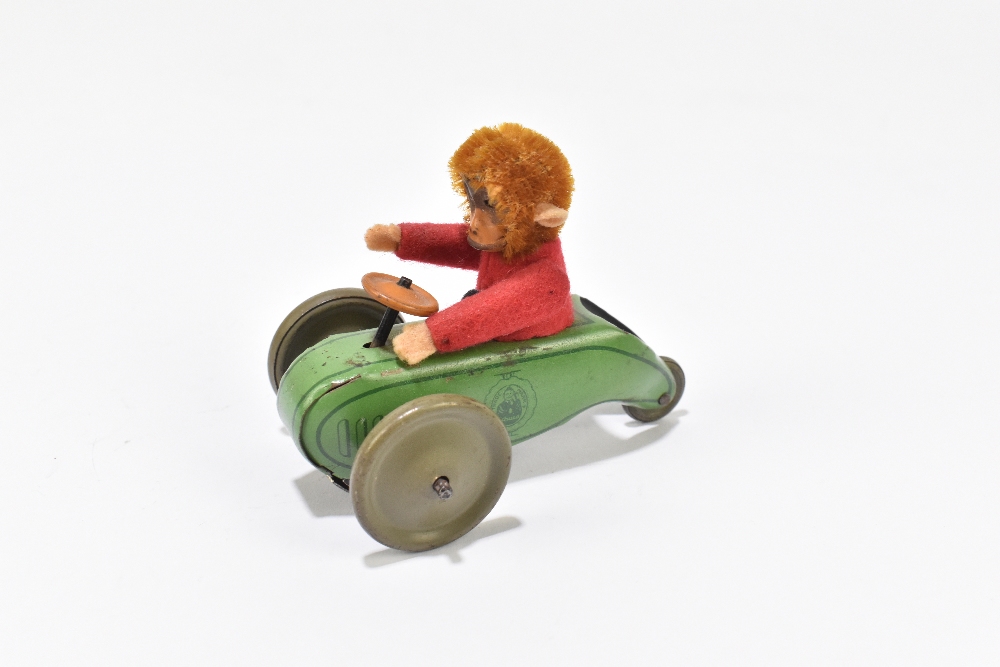 SCHUCO; a tinplate friction model of a three wheel motorcar with monkey driver, length 9cm. - Bild 2 aus 5