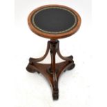 An occasional table with leather lined top on a 19th century pole screen base, height 53cm.