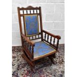 An early 20th century walnut American style rocking chair.
