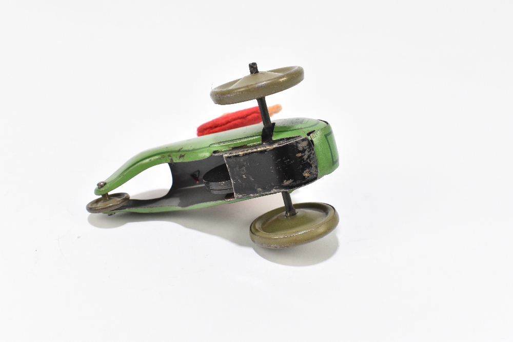 SCHUCO; a tinplate friction model of a three wheel motorcar with monkey driver, length 9cm. - Bild 5 aus 5