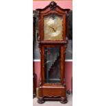 A substantial late Victorian/Edwardian mahogany longcase clock with elaborate scroll dial set with