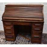 An early 20th century oak roll top desk, width 120cm.