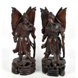 A pair of Chinese carved rootwood figures representing warriors on naturalistic plinth bases, height