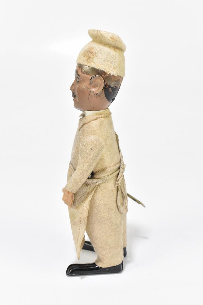 SCHUCO; a German tinplate clockwork model of a chef, with felt clothes and cotton apron, height 16. - Bild 5 aus 6