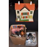 A miscellany of celluloid dolls and doll's clothes, with a vintage doll's house with metal