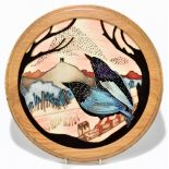 MOORCROFT; a circular wall plaque fitted in white oak frame decorated in the 'Starling