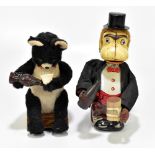 Two Japanese battery operated toys comprising a drinking monkey with tinplate face and a drinking